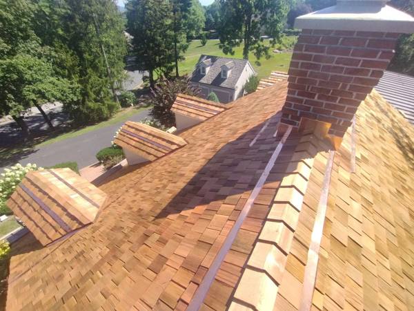 Cedar shake roof with chimney and dormers