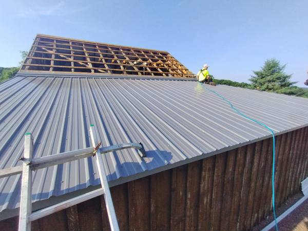 Metal roof installation on a barn