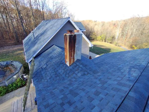 Shingle roof with brick chimney
